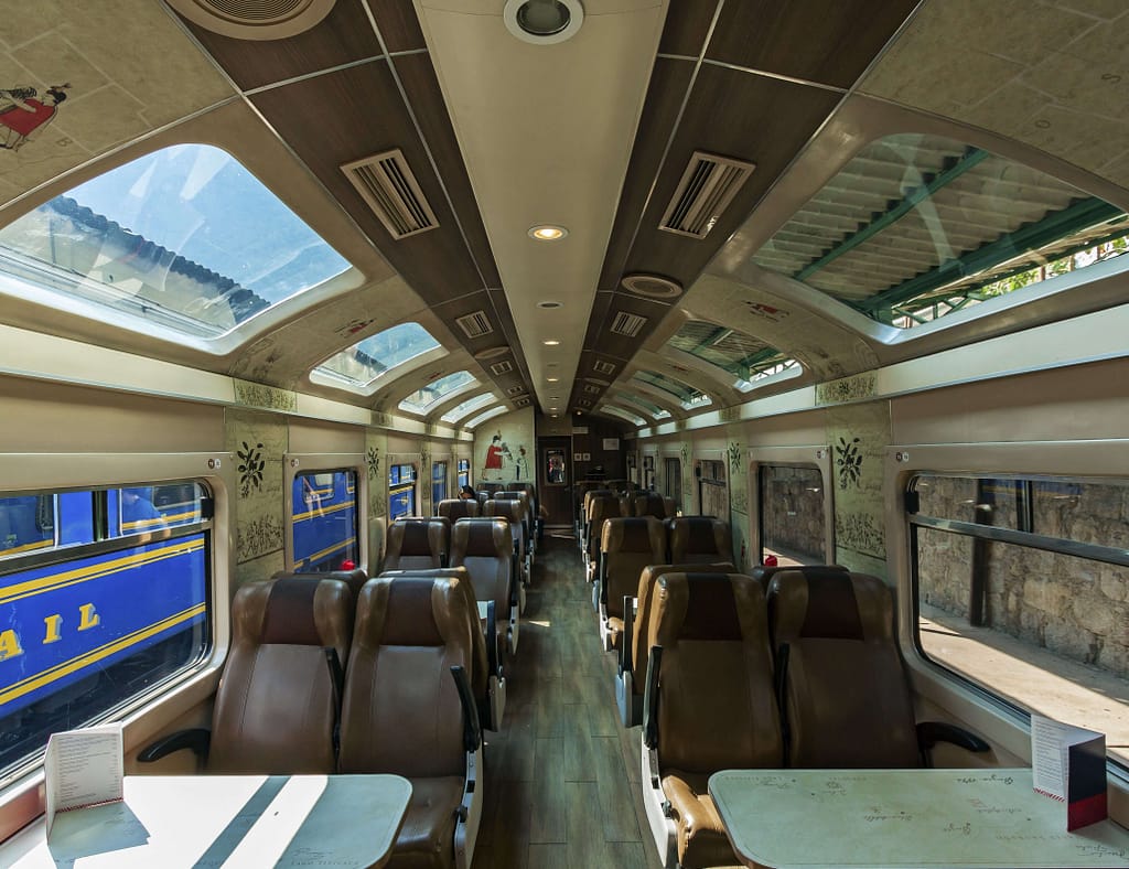 Inside of the Vistadome train, rows of seats and a glass ceiling